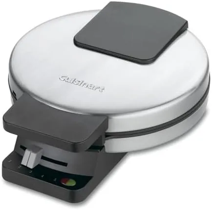 The waffle maker being wiped clean after a cooking session