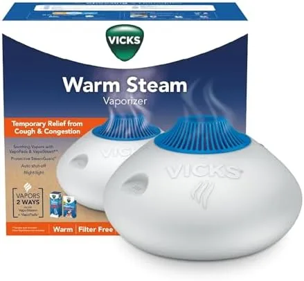 The Vicks warm steam vaporizer on a nightstand in a bedroom