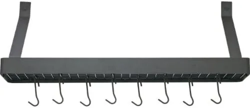 A cast iron pan hanging from the oval pot rack during daily kitchen use