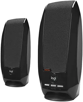 Logitech S150 USB speakers sitting on a desk next to a laptop