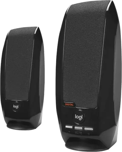 Logitech S150 next to a larger speaker set with a subwoofer for comparison