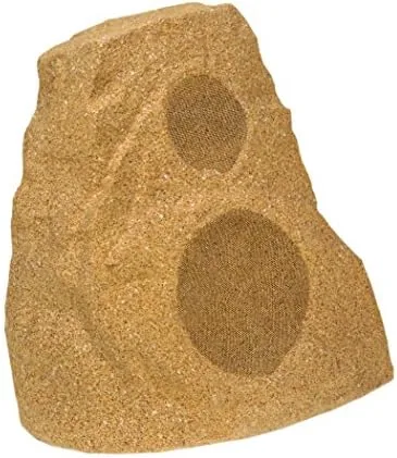 Two Klipsch rock speakers positioned along a backyard patio
