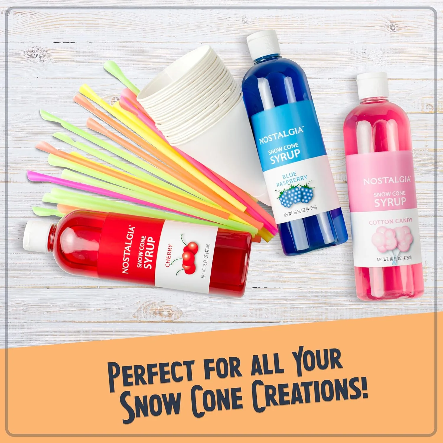 Snow cone party spread with the Nostalgia machine, cups, and syrup bottles