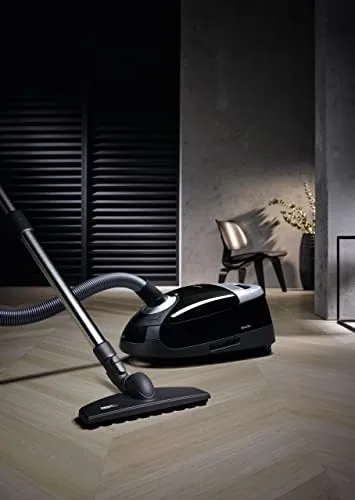 The brush in use on a laminate floor in a bright hallway