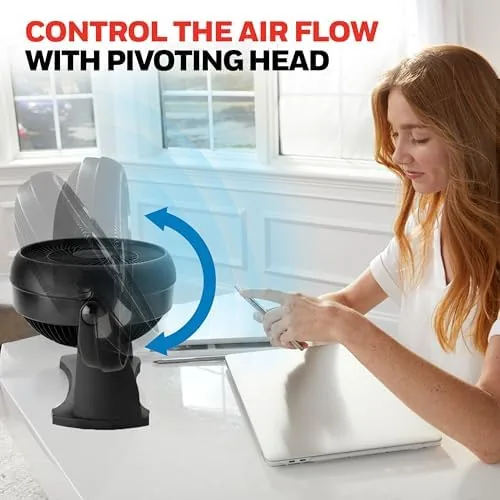 The black HT900 next to a standard open bladed desk fan