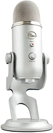 The silver Blue Yeti standing on its base on a desk