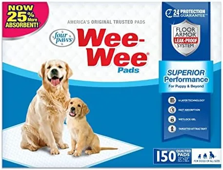 A stack of Four Paws Wee-Wee pads with a single pad unfolded on the floor
