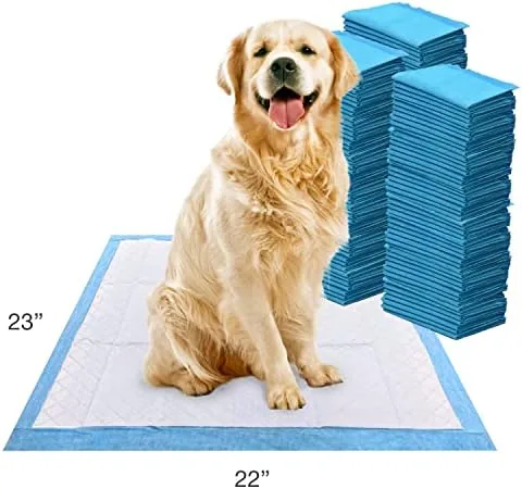 A stack of the pads and a roll beside a puppy bed