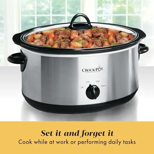 Slow cooker on the table with the lid off and dinner served