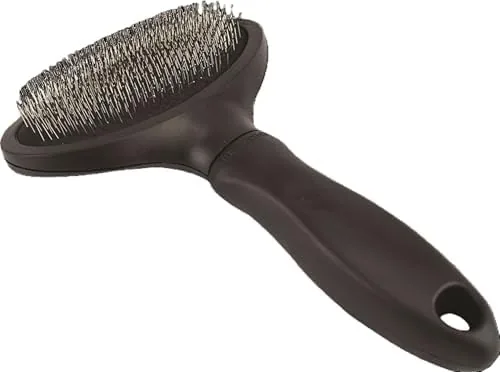 Close-up of the Miracle Care brush pins curving against the fur of a cat