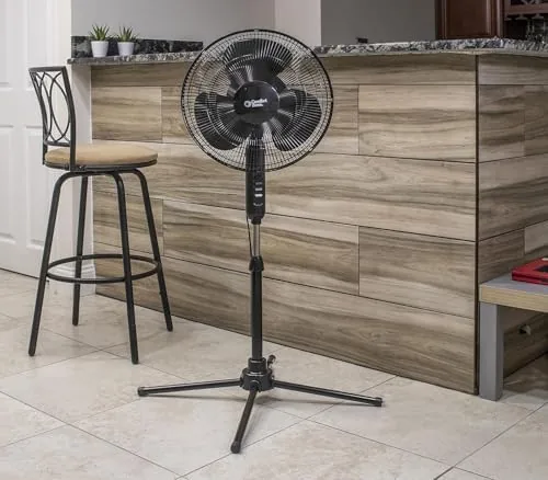 Pedestal fan positioned next to a desk in a home office