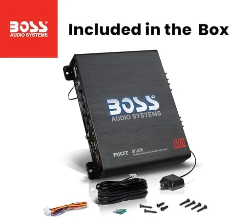 Two car amplifiers compared on a bench with a subwoofer