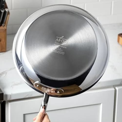 Cook pouring melted chocolate from the butter warmer onto a baking tray
