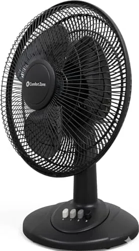 Comfort Zone 12 inch table fan on a desk with a laptop