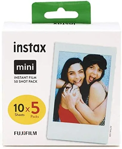 Instax Mini prints pinned and taped onto a wall collection