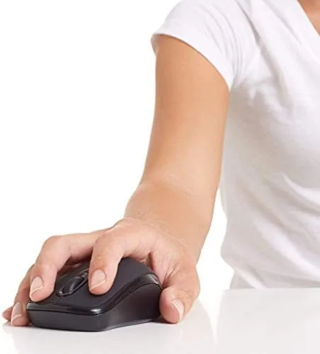 The wireless mouse in the hand, held casually above a desk