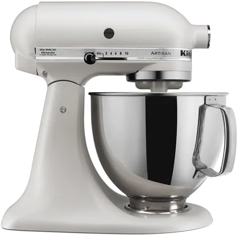 A testing notebook next to the mixer recording times for whipped cream and bread dough