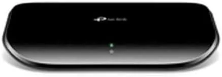 The switch installed behind a desk connecting a desktop and a NAS