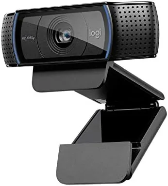 The Logitech C920 webcam sitting on a desk with its lens facing forward