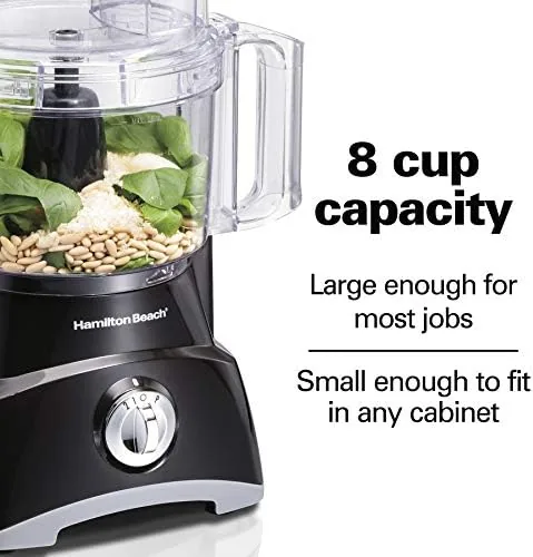 The food processor in use shredding a block of cheddar cheese into a bowl