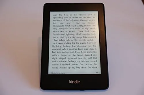 The Kindle open to a page with the built in light in a dark room