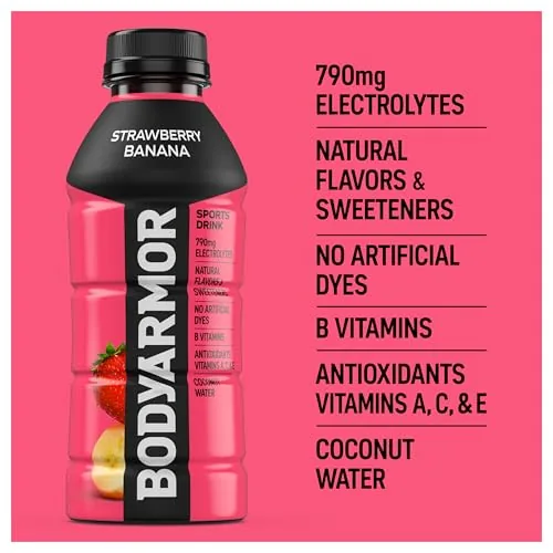 A glass of BODYARMOR Strawberry Banana poured and held up to the light