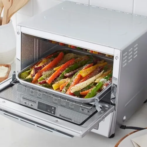 The toaster oven with the crumb tray pulled out for cleaning