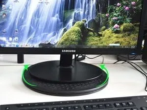 The swivel disc seen beneath a standing desk monitor in active daily use