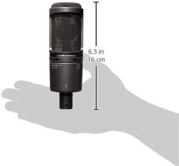 A person speaking into the AT2020USB+ with headphones on for monitoring