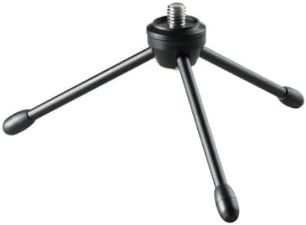 The microphone set up on a boom arm above a desk for hands free recording