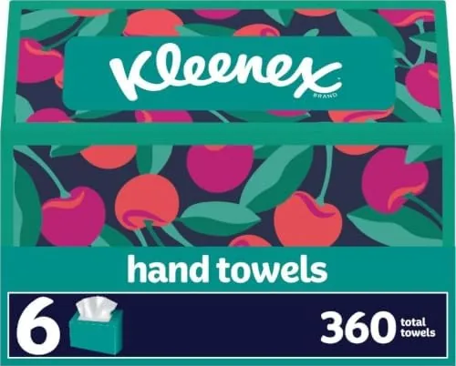 Three Kleenex paper hand towel boxes stacked on a kitchen counter