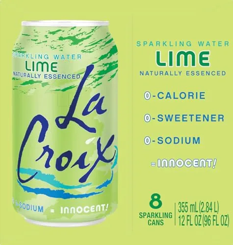 A glass of La Croix lime with ice next to a laptop on a desk
