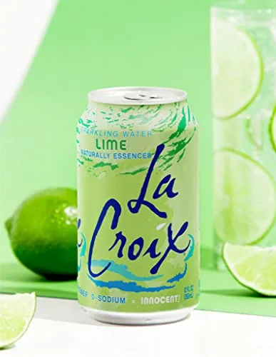 A tray of La Croix lime cans and glasses on a patio table