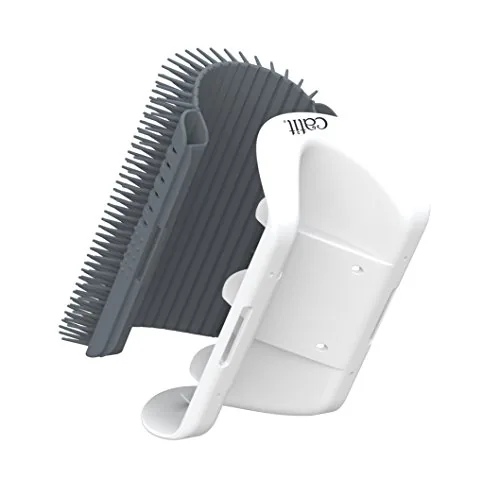 The Catit Senses 2.0 self groomer mounted on a wall with a cat approaching it