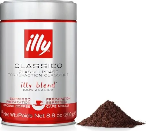 Red illy Classico espresso tin on a kitchen counter with a glass cup of espresso