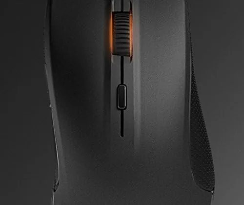 The SteelSeries Rival on a desk next to a keyboard in a gaming setup