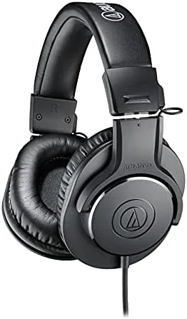 The Audio-Technica ATH-M20x headphones in black, lying beside their coiled cable