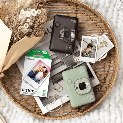 Four Instax cameras with freshly developed Mini prints laid out in front of them