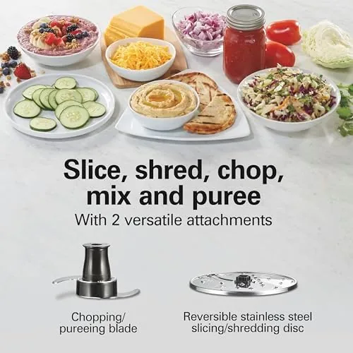 The food processor bowl filled with chopped vegetables and herbs