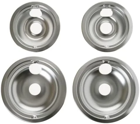 Four GE drip pans arranged on a kitchen counter beside an electric range