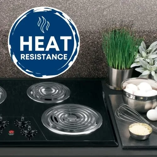 A clean kitchen with the fresh drip pans installed under all four burners