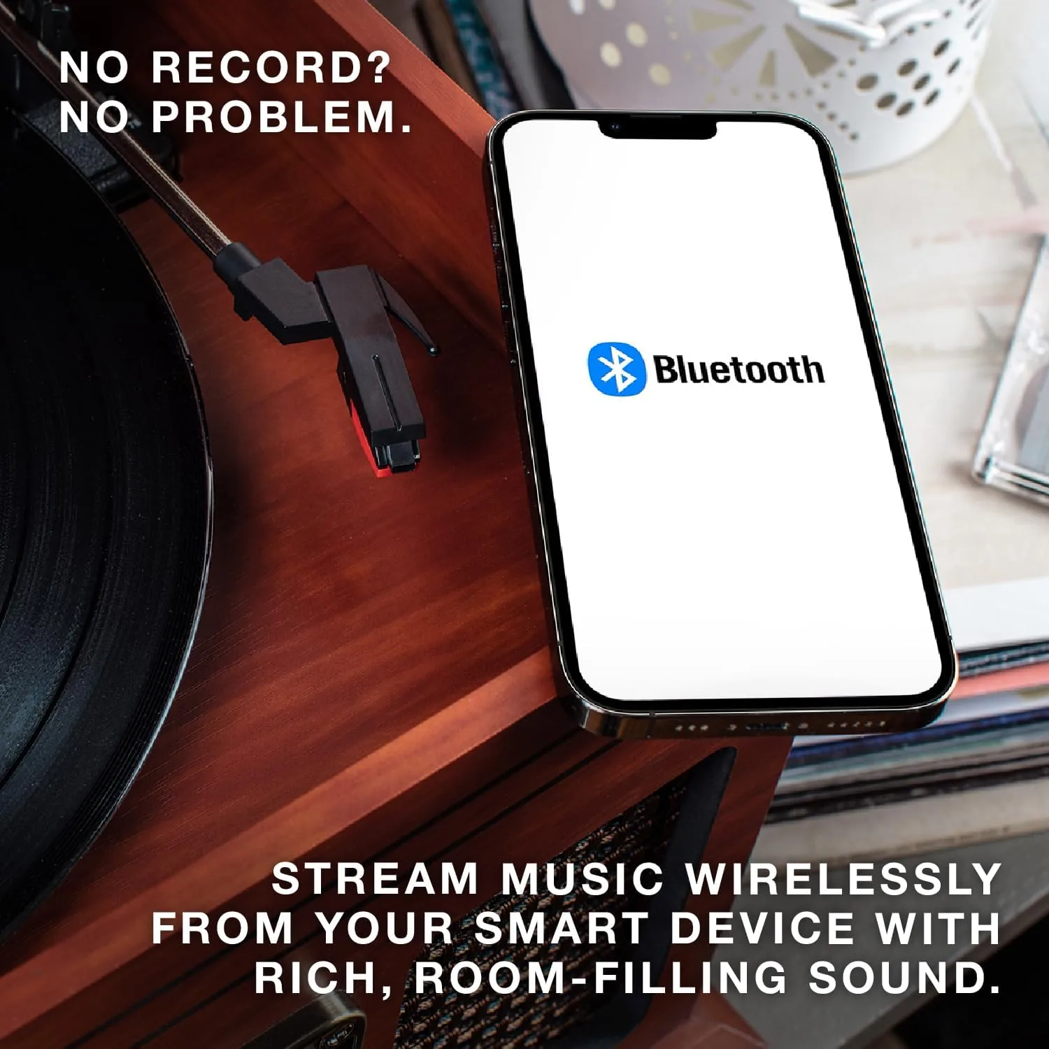 A vinyl record spinning on the turntable with the tone arm in place