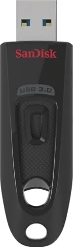 A hand inserting the SanDisk Ultra into a laptop USB port