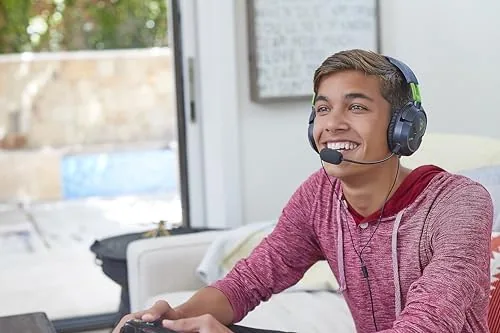 Headset connected to a controller and a PC on a desk setup