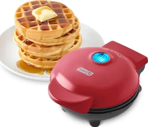 Dash Mini waffle maker in red on a kitchen counter showing its small size