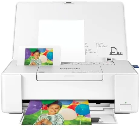 The white Epson PictureMate PM-400 sitting on a desk with a printed photo coming out
