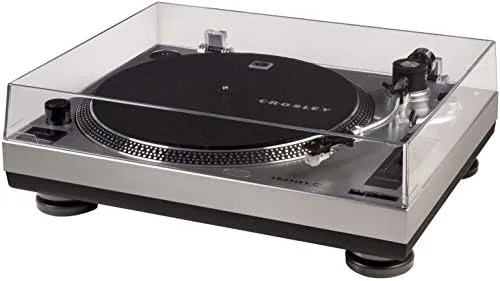 The silver Crosley C100A-SI turntable on a media console with a record playing