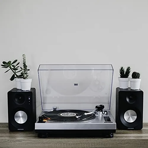 A shelf of vinyl records beside the Crosley C100A turntable and powered speakers