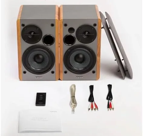 A laptop playing music connected to the Edifier R1280T speakers