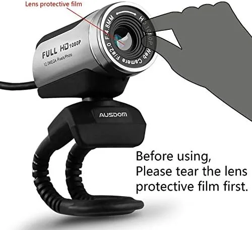 A home office desk setup showing the AUSDOM webcam mounted above a monitor